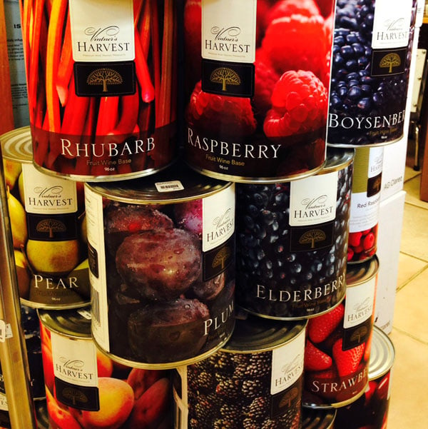 Cans of fruit base in different fruit flavors for winemaking