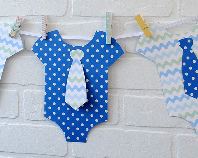 Close up of DIY baby onesie party banner