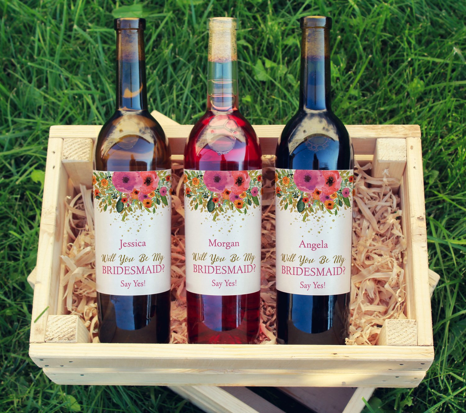 Bottles of wine with bridesmaid labels on them.