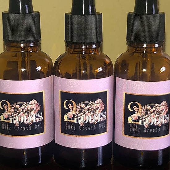 Hair growth oil in dropper bottles with custom stickers.
