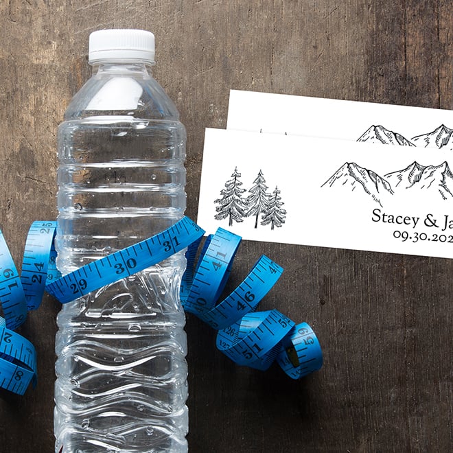 How to measure a bottle for custom labels. Water bottle labels, bottle, and tape measure.