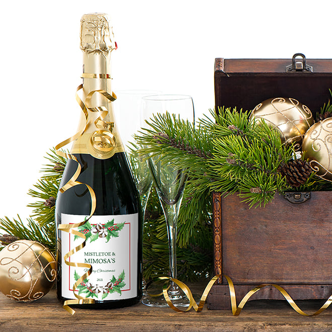 Mistletoe and Mimosas saying on a Christmas Champagne label. Personalized Christmas drink labels are simple to make and are elegant party favors.
