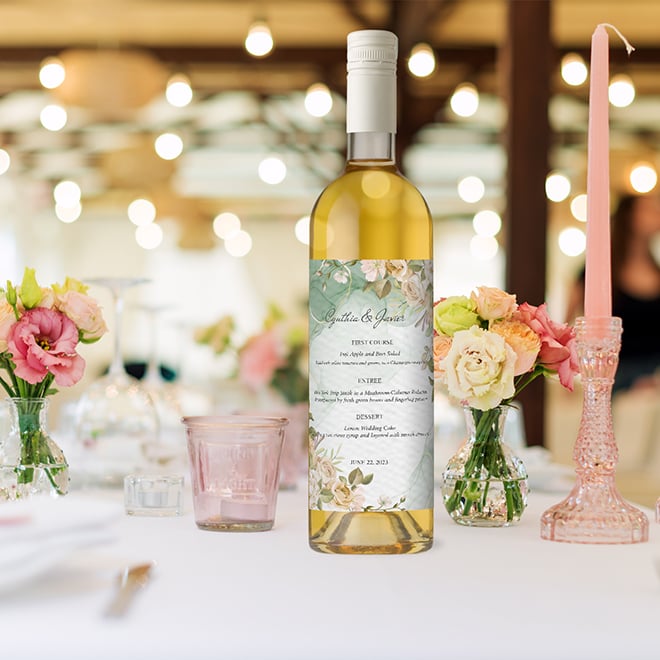 This customizable wedding wine label menu features mixed watercolor greenery leaves and pastel roses paired with a elegant font perfect for a wedding menu.
