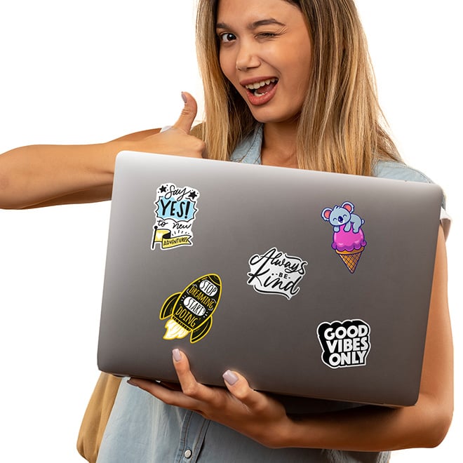 Vinyl, gloss laptop stickers on a Mac with a cute girl. Low minimum order quantities make these inspirational stickers great for small teams and team building events.