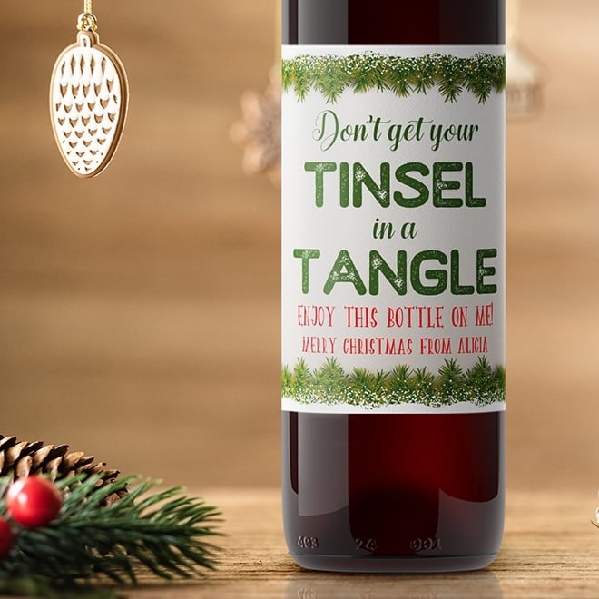 Don't get your tinsel in a tangle funny Christmas wine label. This wine label is bordered by snowy garlands and has room for your greeting.